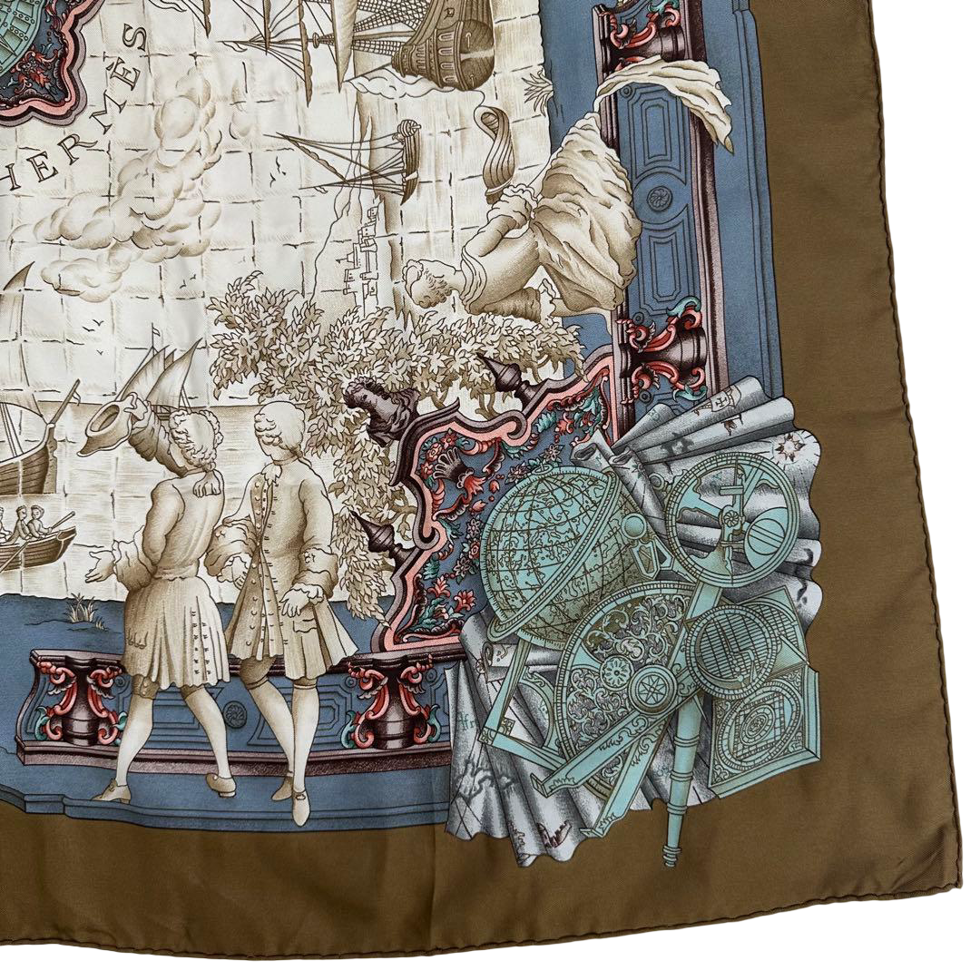 Hermès Carré 90 silk twill scarf, Age of Exploration, bronze border – corner detail, scrolls and instruments on the border