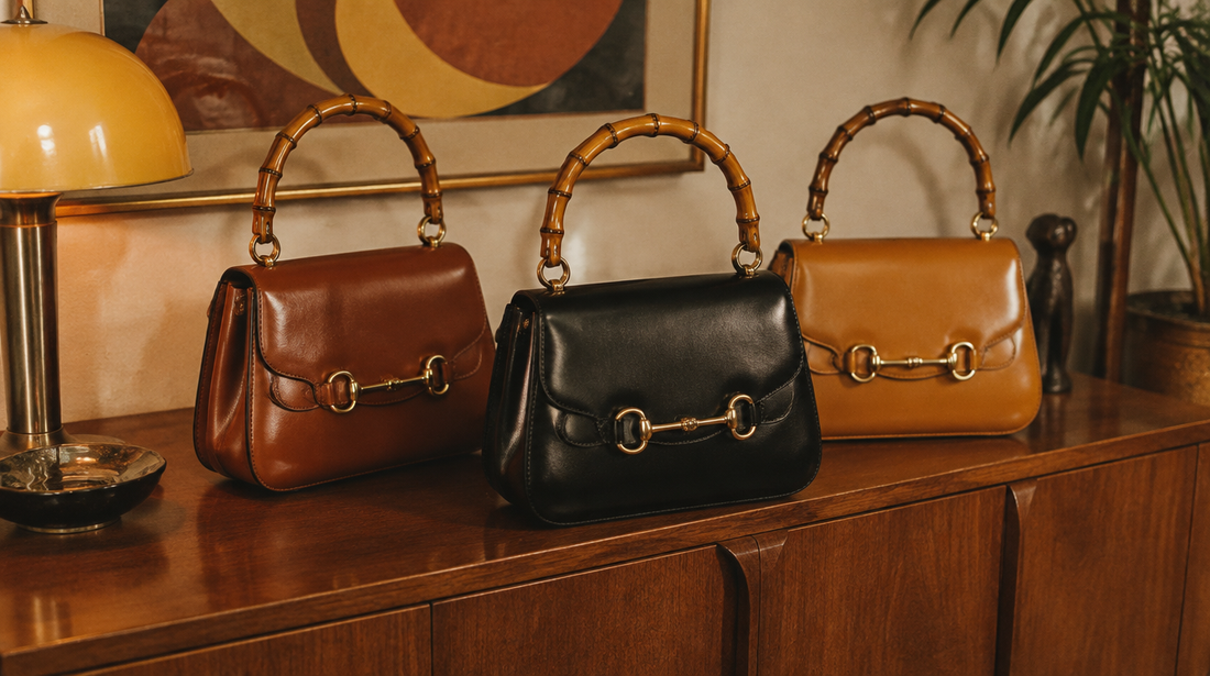 Vintage Italian leather handbags with curved bamboo handles and a horse-bit ornament on a mid-century sideboard