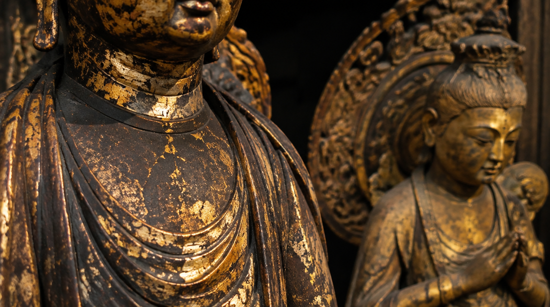 Worn gold leaf over black lacquer on carved wood beside a small gilt bronze figure