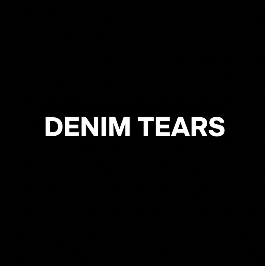 Denim Tears wordmark in white on black square background, monochrome contemporary fashion brand plate