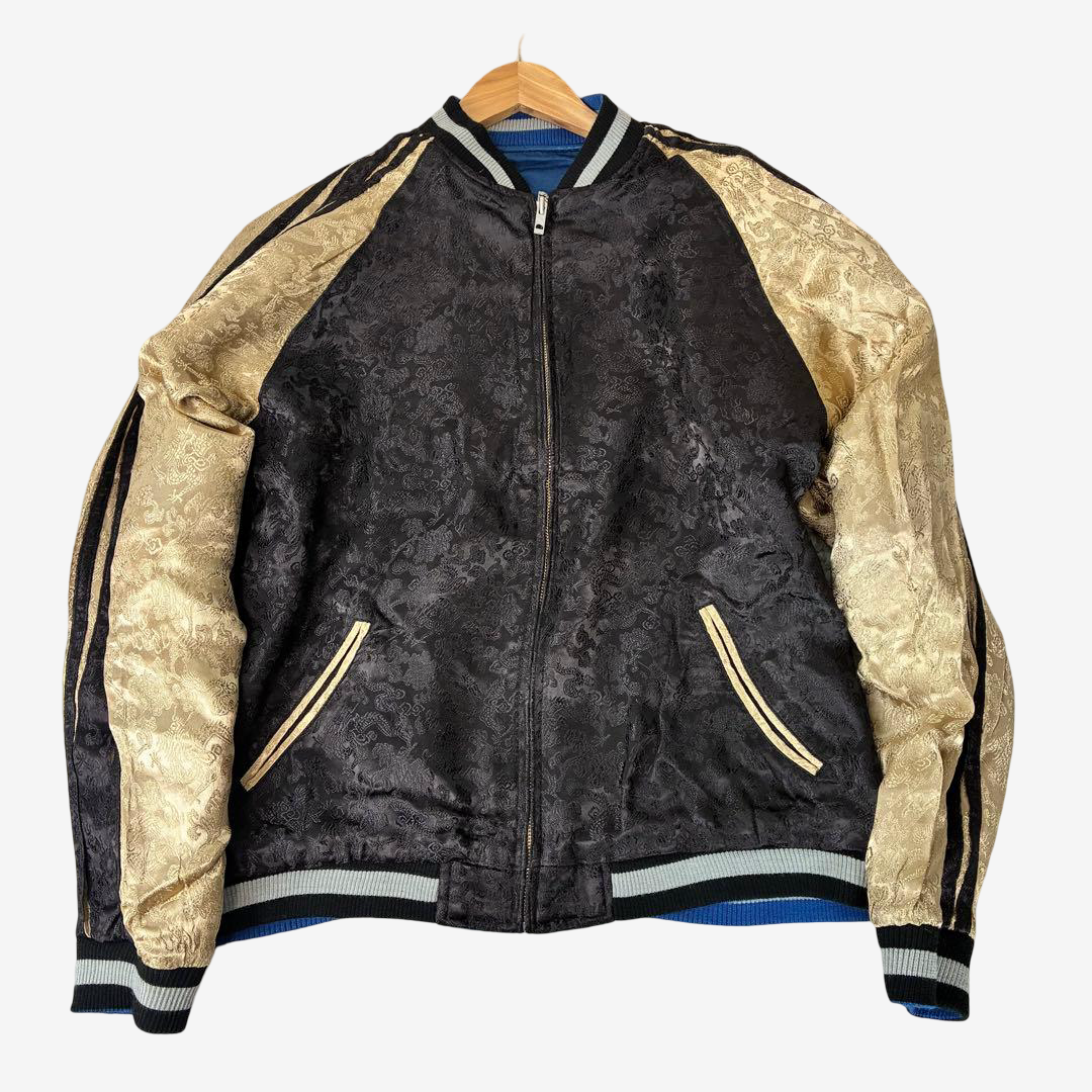 Rare reversible Sukajan jacket featuring black textured body and gold dragon brocade sleeves with striped ribbing.