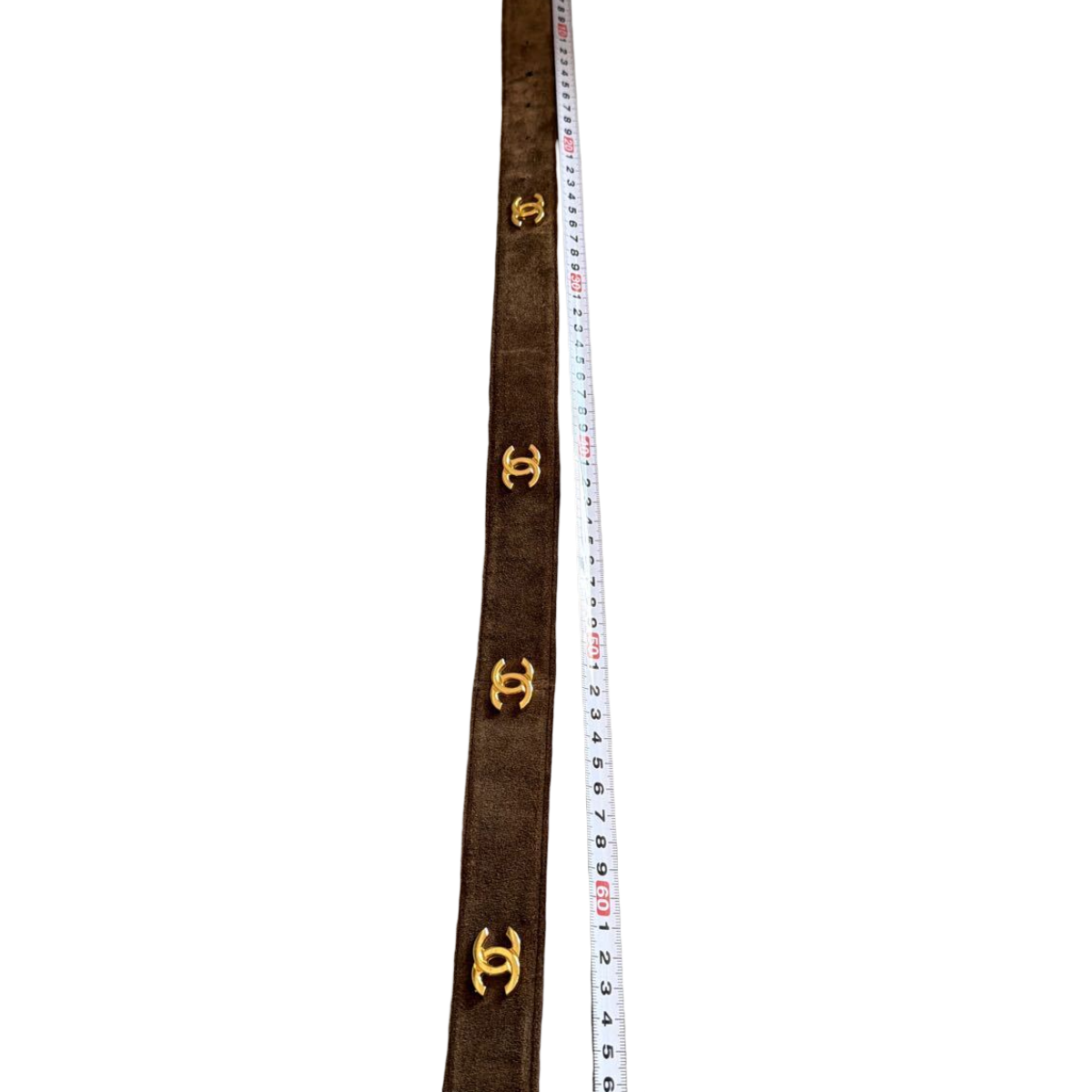 Chanel brown suede belt with chain-woven CC buckle, vintage – belt beside a ruler, CC medallions along the strap